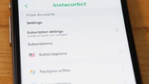 Close-up of a smartphone screen displaying the Instacart mobile app account settings menu with subscription options visible, showing clean interface design with white background