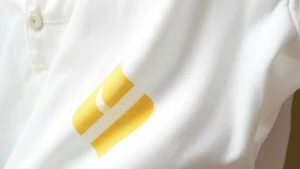 Close-up of white cotton fabric with yellow armpit stain visible, natural daylight, realistic textile surface showing discoloration and fabric weave detail
